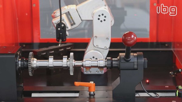 Close-up view of the ibg eddyrobot mobile test system, focusing on its components as it performs a test on a rotor shaft for quality assurance.